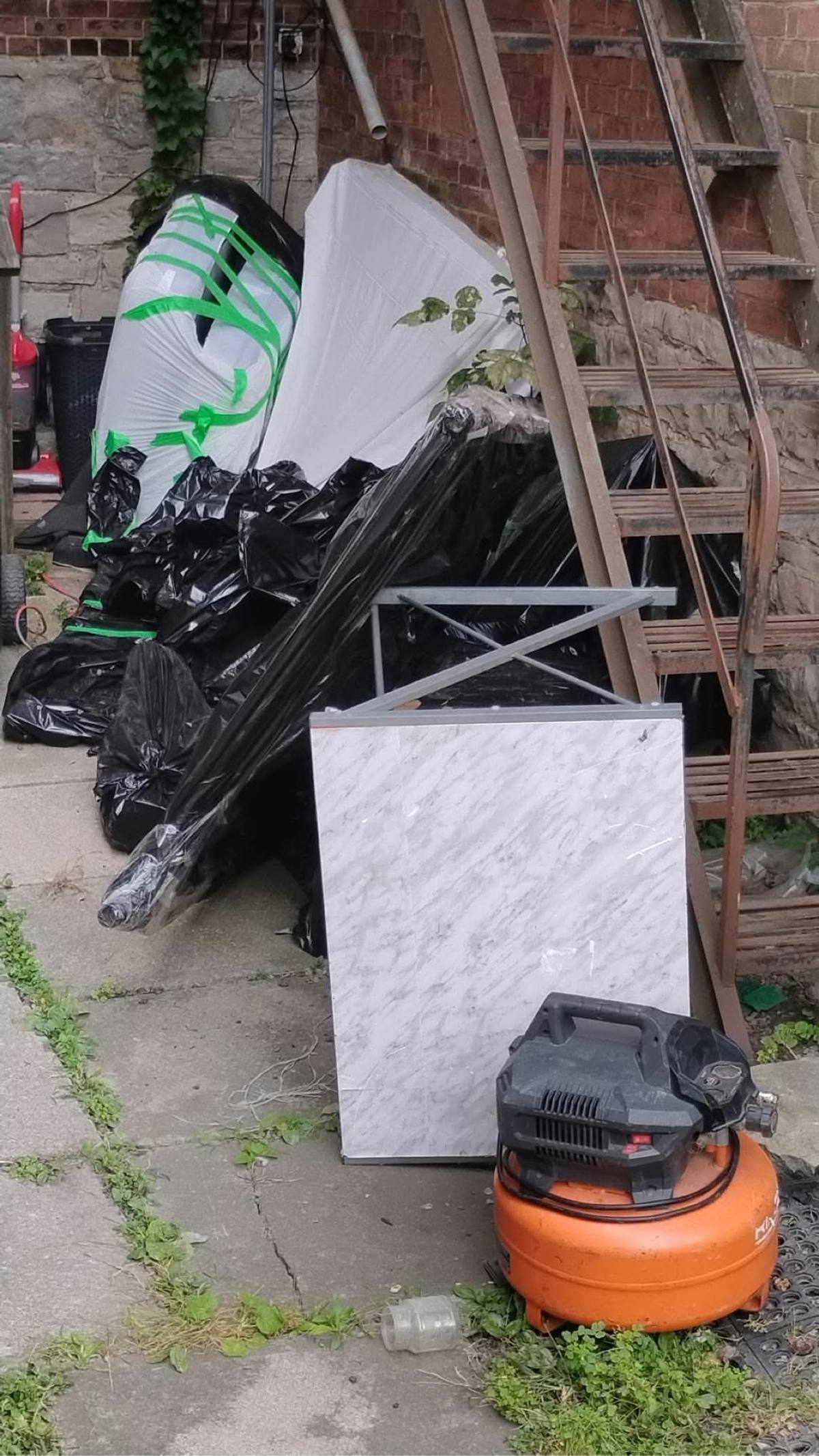 Junk piled by stairs before removal